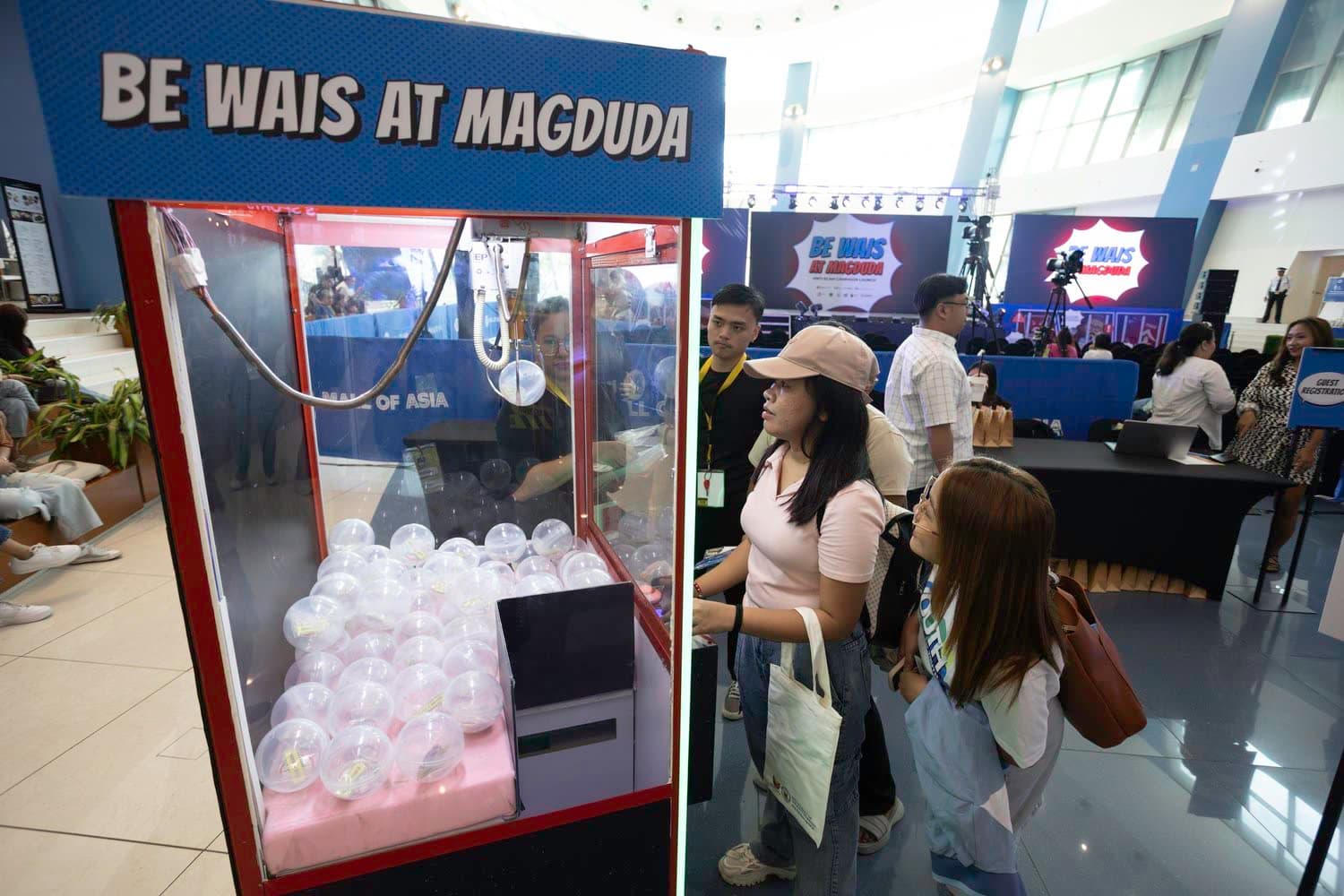 Information through gamification: mascot keychains won through claw machine participation.